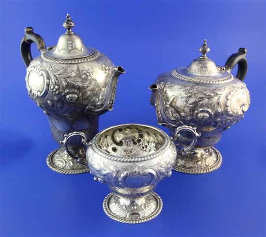 A late Victorian repousse silver part three piece tea and coffee set by Mappin Brothers, gross 49.5 oz.